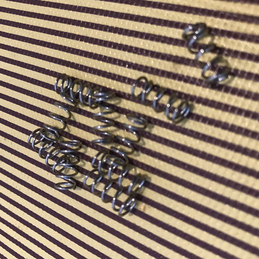 Electric guitar bridge spring